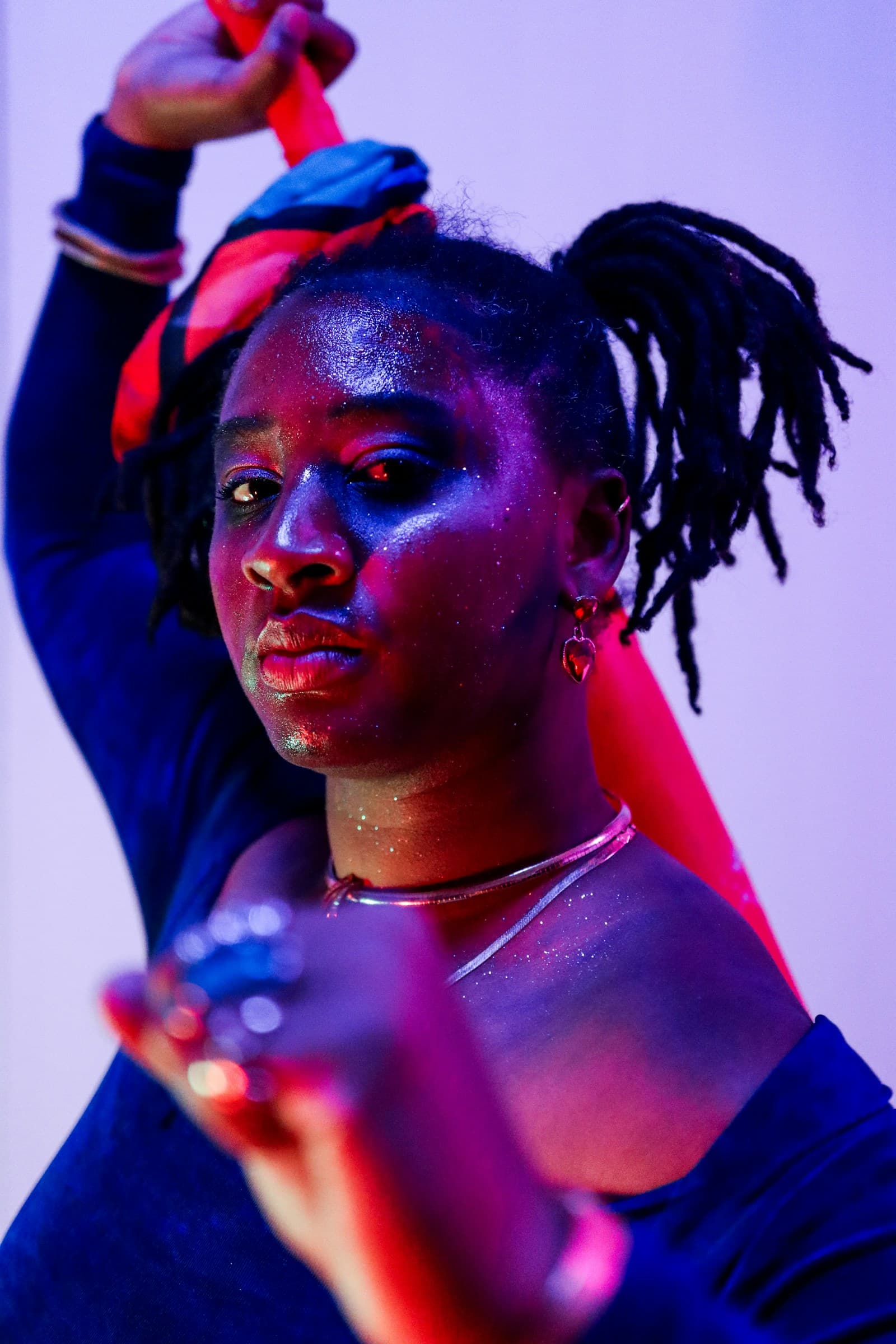 Colorful editorial portrait under blue and red lights
