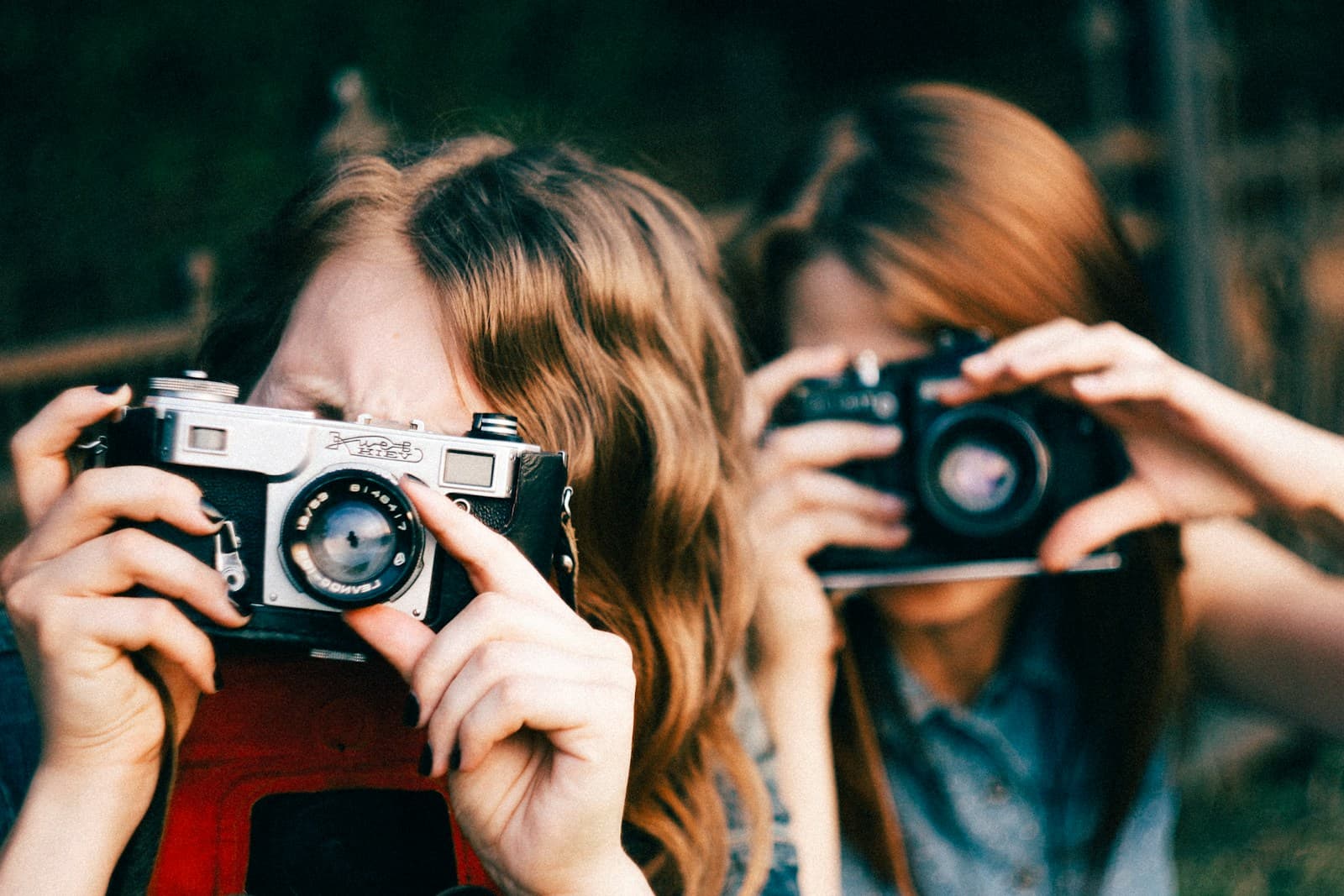Women photographing with a vintage camera